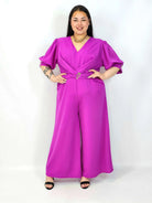 Kombinezon plus size z kopertowym dekoltem i paskiem – elegancki fason XXL Stylowa XL
