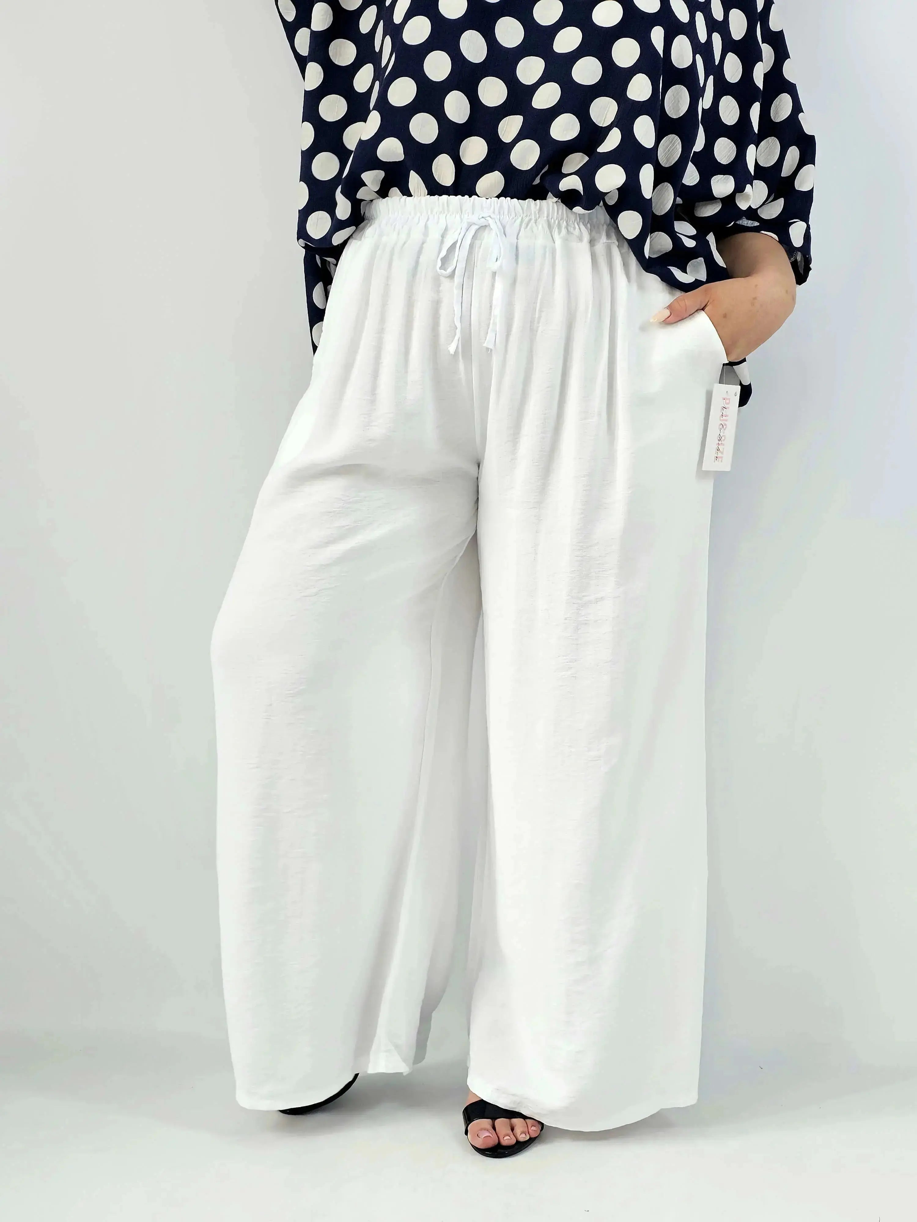 Spodnie wiskozowe plus size XXL – szerokie spodnie damskie z kieszeniami Stylowa XL