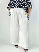 Spodnie wiskozowe plus size XXL – szerokie spodnie damskie z kieszeniami Stylowa XL
